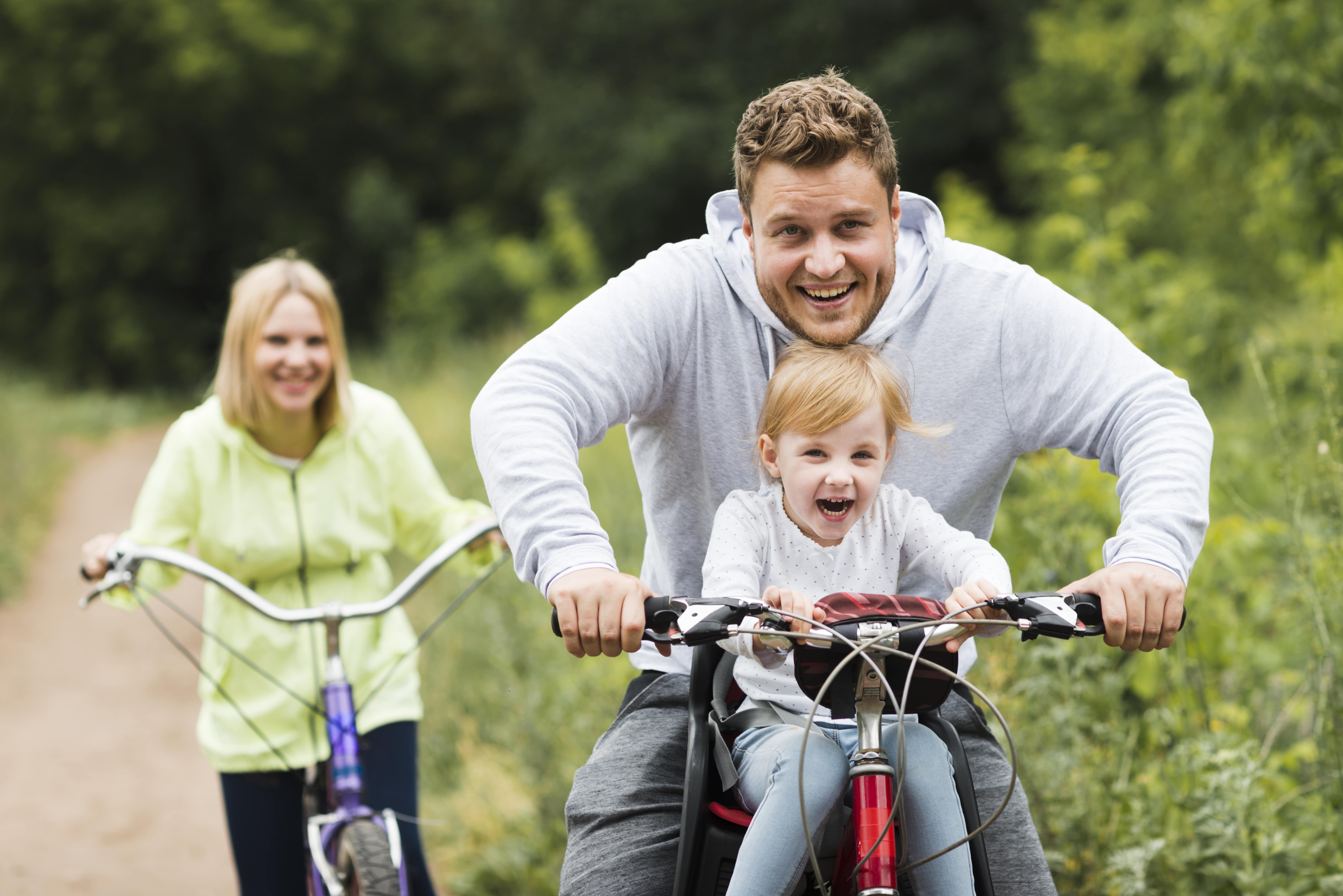 happy-family-with-bikes-forest-road-min